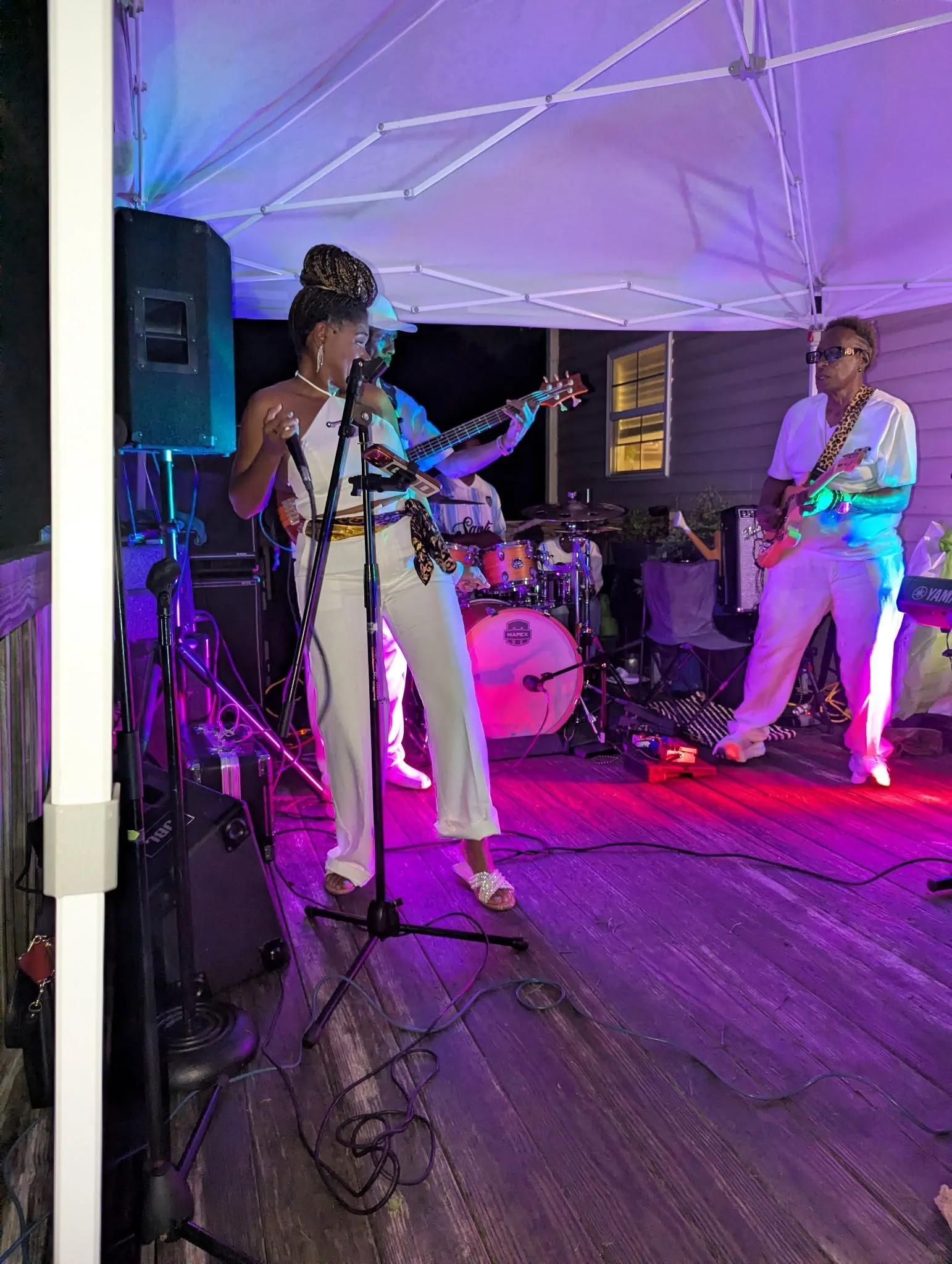Live musicians performing beneath a canopy during Goins 2Get United