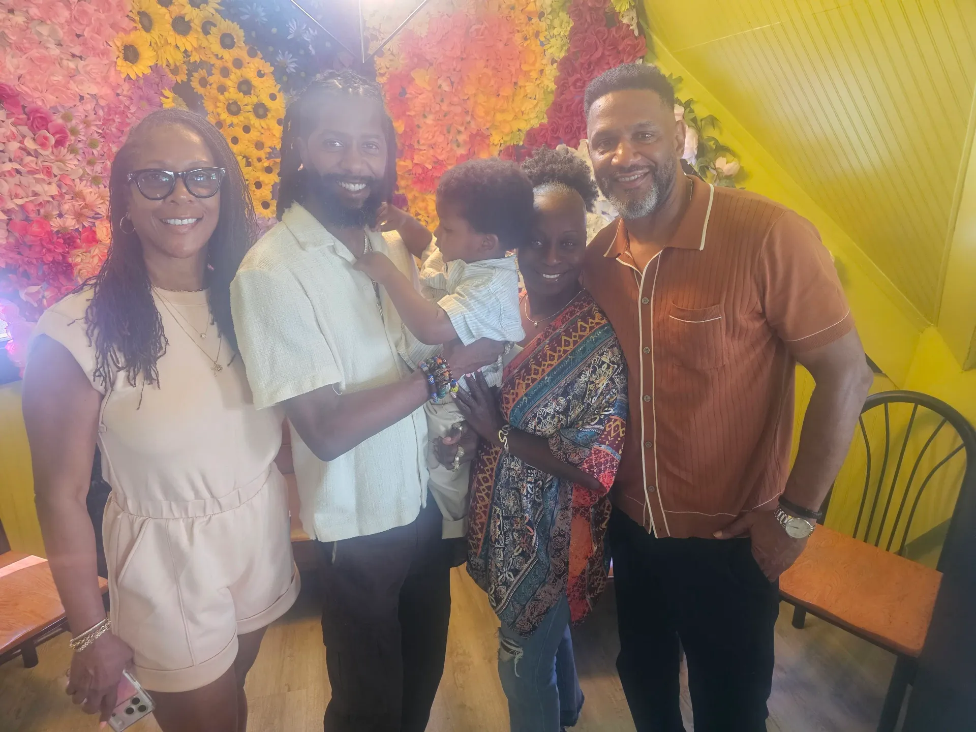 Family and friends smiling together at the community pop-up